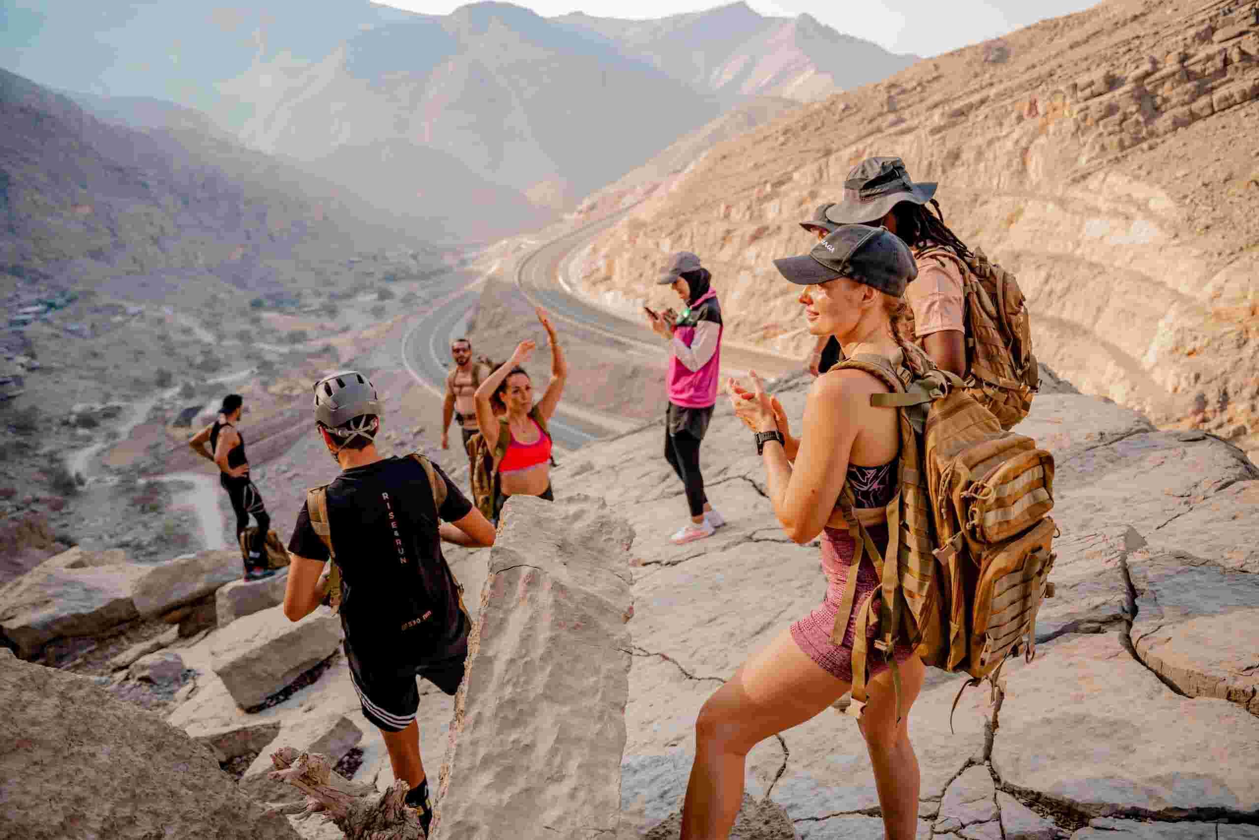 Group of hikers exploring scenic trails at Jebel Jais Adventure Park in Ras Al Khaimah, surrounded by the rugged Hajar mountains.