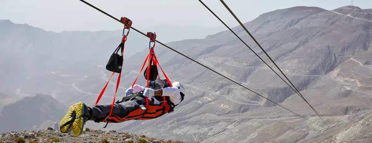 Thrill-seeker flying on the Jebel Jais Flight, the world’s longest zipline, over the majestic Hajar mountains in Ras Al Khaimah.